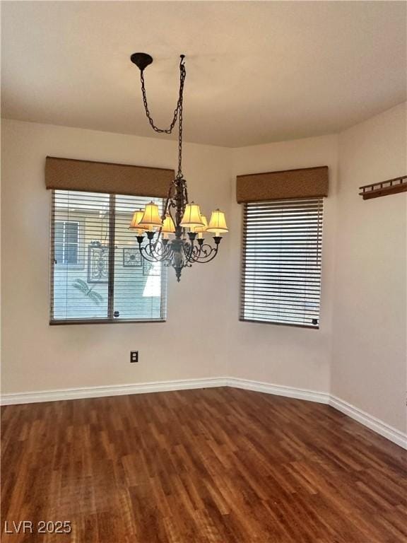2138 Grand Traverse St, Henderson, NV 89052 - unfurnished dining area with dark wood-style flooring, baseboards, and a chandelier