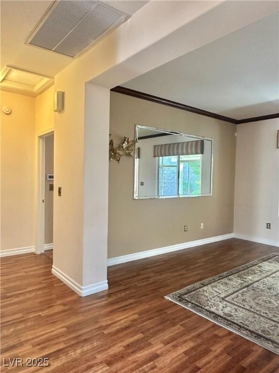 2138 Grand Traverse St, Henderson, NV 89052 - spare room with wood finished floors, baseboards, crown molding, and attic access