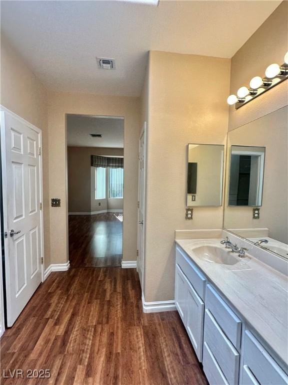 2138 Grand Traverse St, Henderson, NV 89052 - bathroom with wood finished floors, vanity, and baseboards