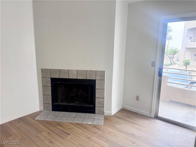 2160 Highpointe Dr Unit 102, Laughlin, NV 89029 - detailed view of wood finished floors, a tile fireplace, and baseboards