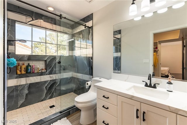 2845 Queens Courtyard Dr, Las Vegas, NV 89109 - bathroom with a shower stall, toilet, vanity, and wood finished floors