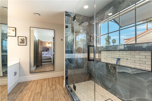 2845 Queens Courtyard Dr, Las Vegas, NV 89109 - bathroom featuring ensuite bathroom, a shower stall, vanity, baseboards, and wood finished floors