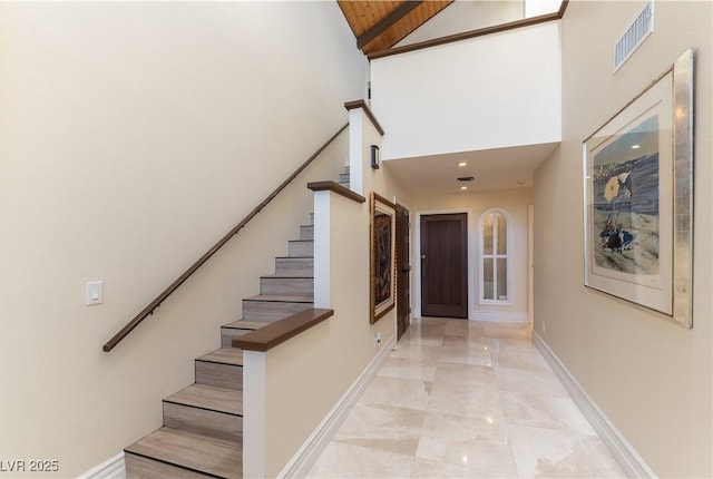 2845 Queens Courtyard Dr, Las Vegas, NV 89109 - stairway with a towering ceiling, marble tiled flooring, and baseboards