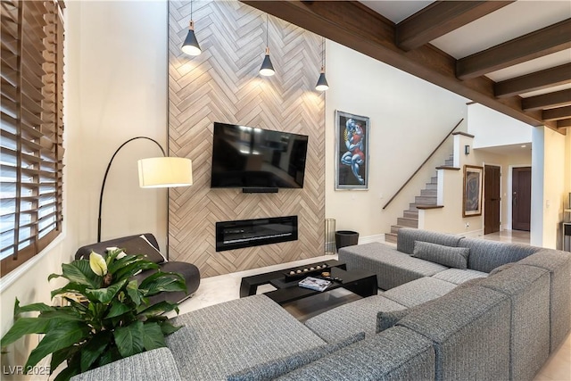 2845 Queens Courtyard Dr, Las Vegas, NV 89109 - living room featuring beamed ceiling, stairs, a fireplace, and baseboards