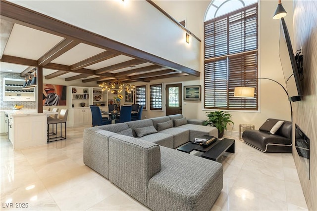 2845 Queens Courtyard Dr, Las Vegas, NV 89109 - living area featuring beamed ceiling, a chandelier, light tile patterned floors, and baseboards