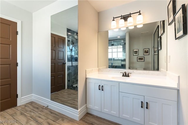 2845 Queens Courtyard Dr, Las Vegas, NV 89109 - full bathroom with wood finished floors, a stall shower, vanity, and baseboards