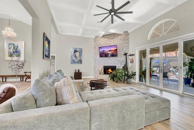 1813 Skyline Dr, Las Vegas, NV 89117 - living area with coffered ceiling, wood finished floors, a fireplace, a ceiling fan, and a chandelier
