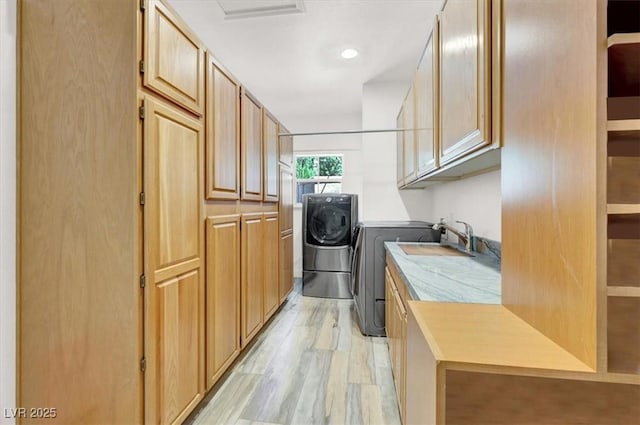 1813 Skyline Dr, Las Vegas, NV 89117 - laundry room with washer and dryer, light wood finished floors, and a sink