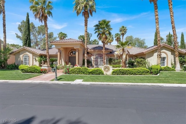 1813 Skyline Dr, Las Vegas, NV 89117 - mediterranean / spanish-style house with stucco siding, a tile roof, and a front yard