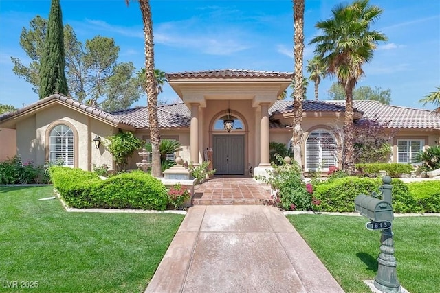 1813 Skyline Dr, Las Vegas, NV 89117 - mediterranean / spanish-style home featuring stucco siding, a tiled roof, and a front lawn