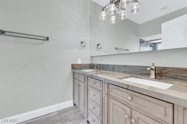 1813 Skyline Dr, Las Vegas, NV 89117 - bathroom featuring double vanity, baseboards, and wood finished floors