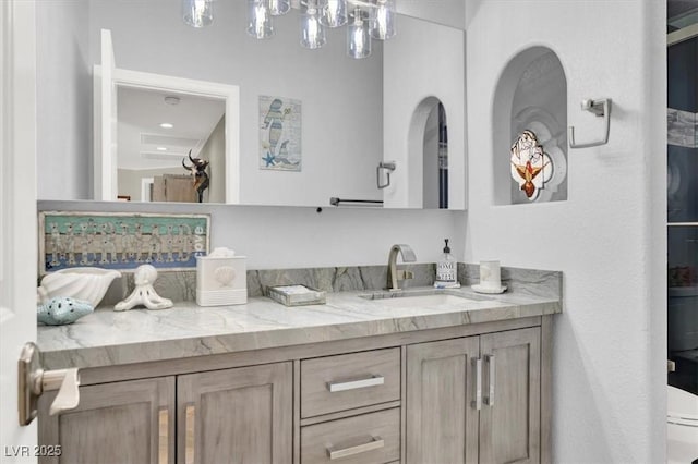 1813 Skyline Dr, Las Vegas, NV 89117 - bathroom with vanity, a chandelier, and toilet