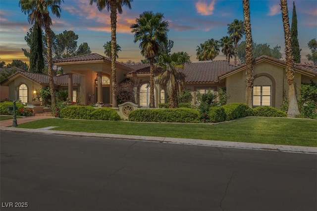 1813 Skyline Dr, Las Vegas, NV 89117 - mediterranean / spanish-style home with a tiled roof, stucco siding, and a front lawn