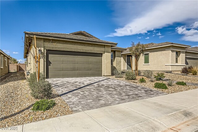6607 Summershade St, North Las Vegas, NV 89086 - view of front of property featuring decorative driveway, stucco siding, and an attached garage