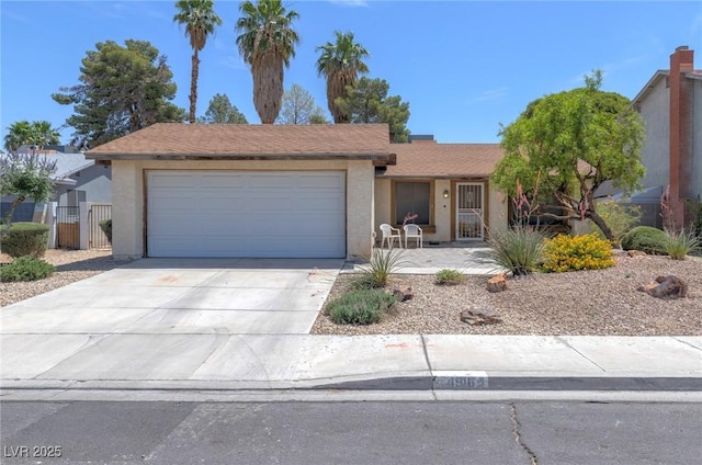 4916 Carmichael Ave, Las Vegas, NV 89110 - single story home with stucco siding, an attached garage, driveway, and a gate