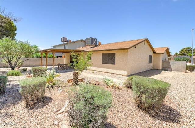 4916 Carmichael Ave, Las Vegas, NV 89110 - rear view of property featuring a patio, stucco siding, a fenced backyard, and cooling unit