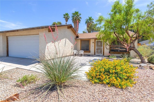 4916 Carmichael Ave, Las Vegas, NV 89110 - view of front of house with an attached garage, stucco siding, and driveway