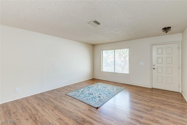 4916 Carmichael Ave, Las Vegas, NV 89110 - entrance foyer with wood finished floors and a textured ceiling