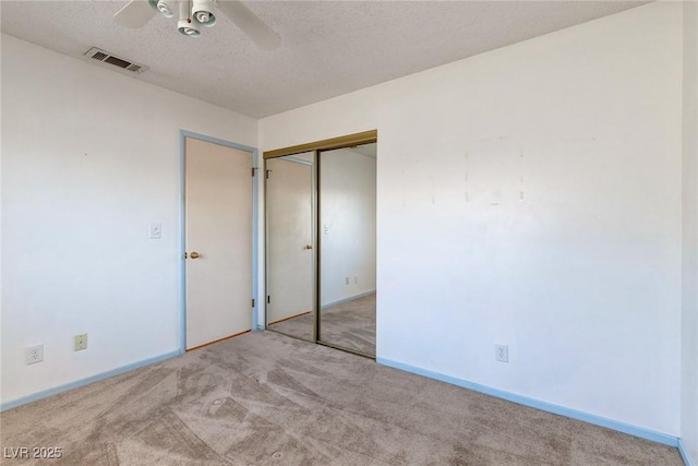 4916 Carmichael Ave, Las Vegas, NV 89110 - unfurnished bedroom featuring carpet floors, a textured ceiling, a closet, baseboards, and a ceiling fan
