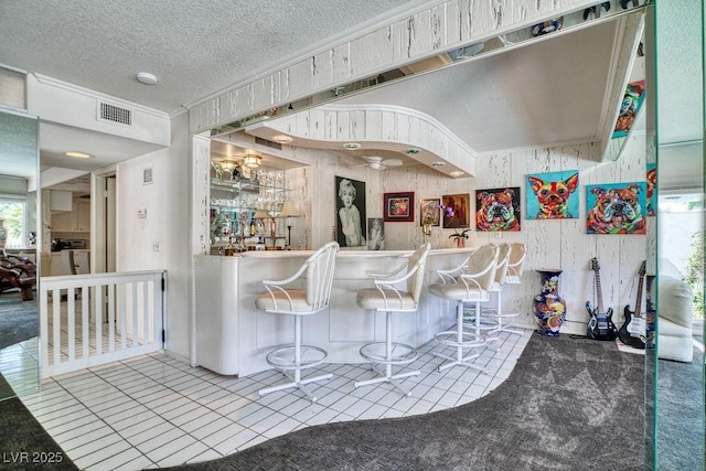 940 Vegas Valley Dr, Las Vegas, NV 89109 - indoor bar featuring a textured ceiling, tile patterned flooring, and crown molding