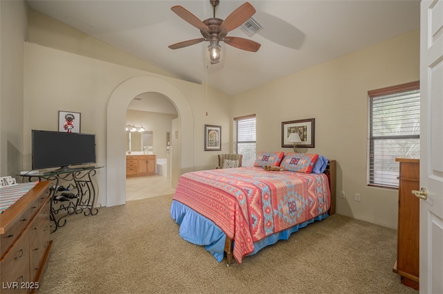 1441 Palm Dr, Laughlin, NV 89029 - bedroom featuring carpet flooring, lofted ceiling, arched walkways, connected bathroom, and ceiling fan