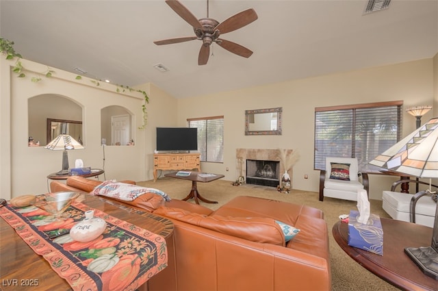 1441 Palm Dr, Laughlin, NV 89029 - carpeted living area featuring a ceiling fan, lofted ceiling, a premium fireplace, and arched walkways