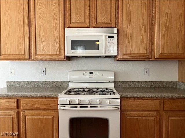 5049 Alfingo St, Las Vegas, NV 89135 - kitchen featuring white appliances and dark countertops