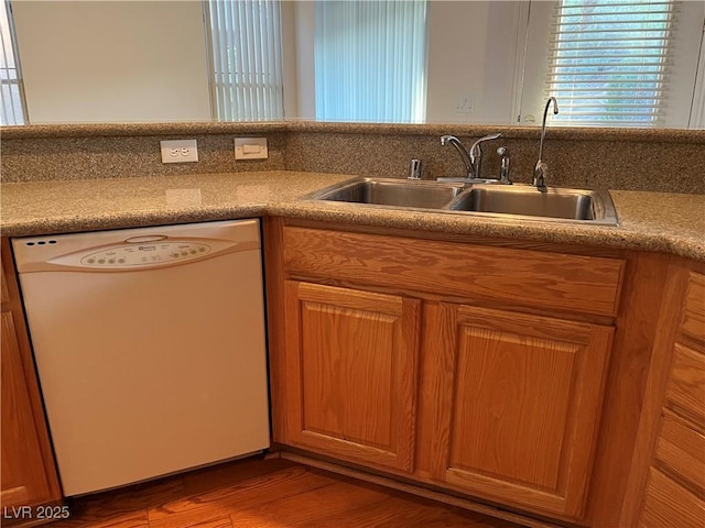 5049 Alfingo St, Las Vegas, NV 89135 - kitchen featuring dishwasher, a sink, wood finished floors, and brown cabinets