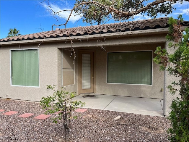 5049 Alfingo St, Las Vegas, NV 89135 - view of front of home with stucco siding, a patio area, and a tile roof