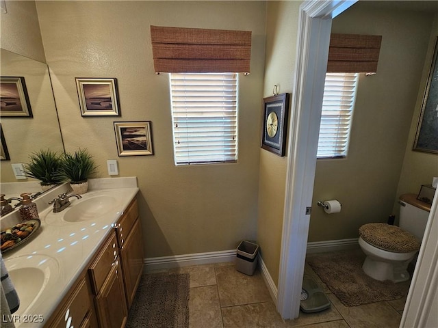 2691 Benton Cove St, Laughlin, NV 89029 - bathroom featuring double vanity, toilet, baseboards, and tile patterned floors