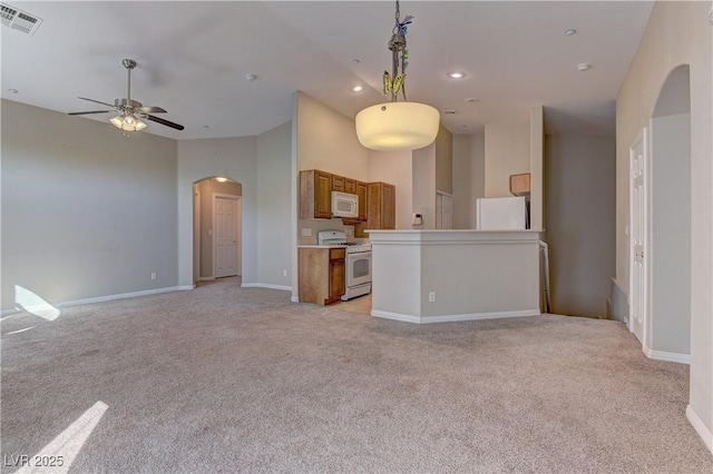 5552 Dueces Wild Ct Unit 101, Las Vegas, NV 89122 - unfurnished living room featuring light colored carpet, arched walkways, ceiling fan, baseboards, and recessed lighting