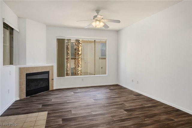 7143 S Durango Dr Unit 202, Las Vegas, NV 89113 - unfurnished living room with wood finished floors, ceiling fan, a tile fireplace, and baseboards