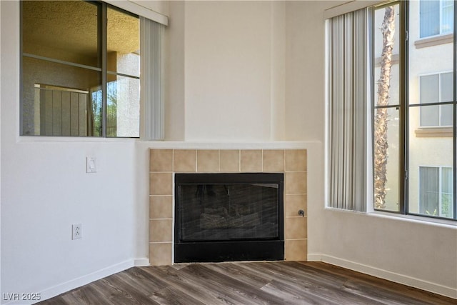 7143 S Durango Dr Unit 202, Las Vegas, NV 89113 - detailed view of wood finished floors, a tiled fireplace, and baseboards