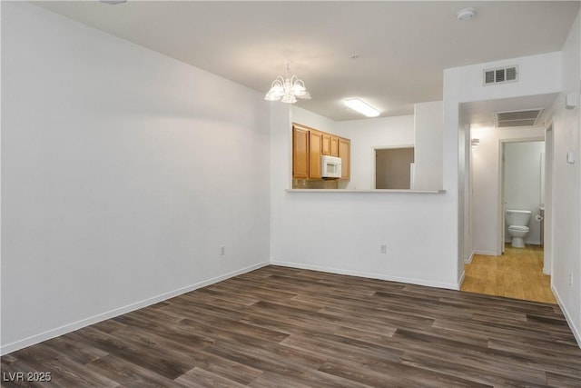 7143 S Durango Dr Unit 202, Las Vegas, NV 89113 - spare room featuring dark wood-type flooring, a chandelier, a smoke detector, and baseboards