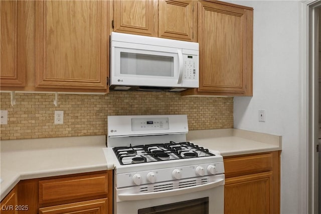 7143 S Durango Dr Unit 202, Las Vegas, NV 89113 - kitchen featuring white appliances, decorative backsplash, and light countertops