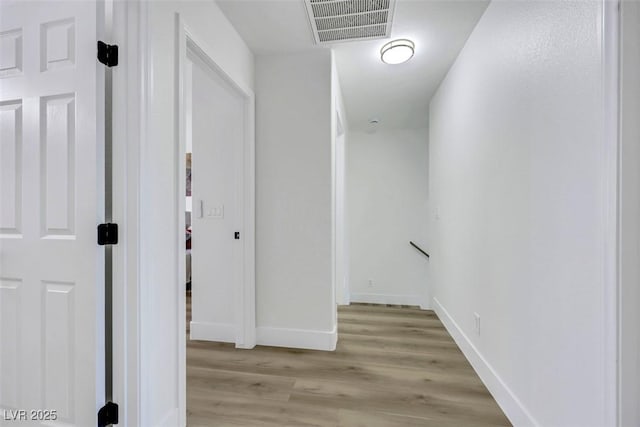 9078 Hilverson Ave, Las Vegas, NV 89148 - hall with light wood finished floors, baseboards, and an upstairs landing