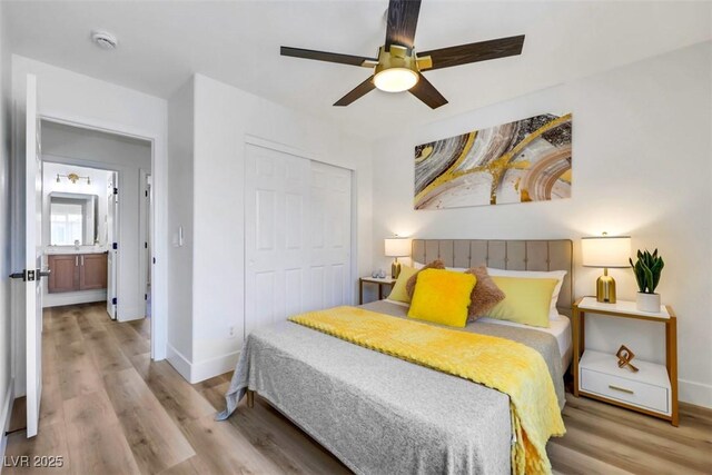 9078 Hilverson Ave, Las Vegas, NV 89148 - bedroom featuring baseboards, wood finished floors, and a closet