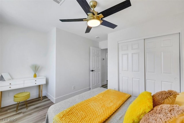 9078 Hilverson Ave, Las Vegas, NV 89148 - bedroom with light wood-style flooring, a closet, baseboards, and a ceiling fan