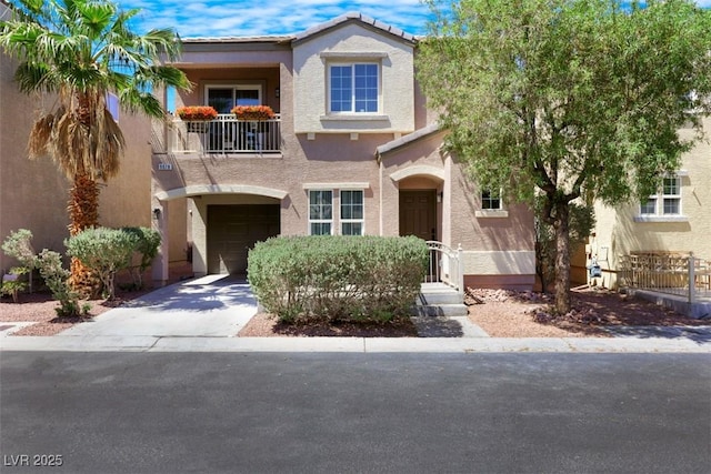 9078 Hilverson Ave, Las Vegas, NV 89148 - view of front facade featuring a balcony, a garage, stucco siding, and driveway