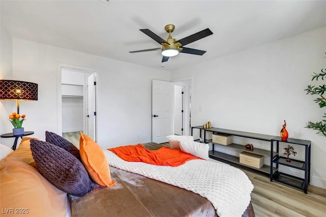 9078 Hilverson Ave, Las Vegas, NV 89148 - bedroom featuring light wood-style flooring, baseboards, a ceiling fan, and a spacious closet