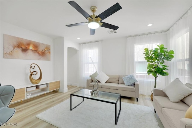 9078 Hilverson Ave, Las Vegas, NV 89148 - living area featuring arched walkways, light wood finished floors, ceiling fan, recessed lighting, and baseboards