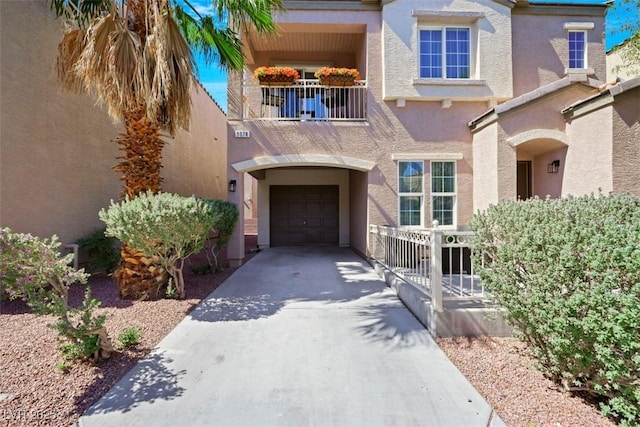 9078 Hilverson Ave, Las Vegas, NV 89148 - view of front of home with a balcony, stucco siding, a garage, and concrete driveway