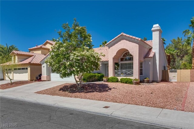 2904 Channel Bay Dr, Las Vegas, NV 89128 - mediterranean / spanish-style house with a tile roof, stucco siding, a garage, driveway, and a chimney