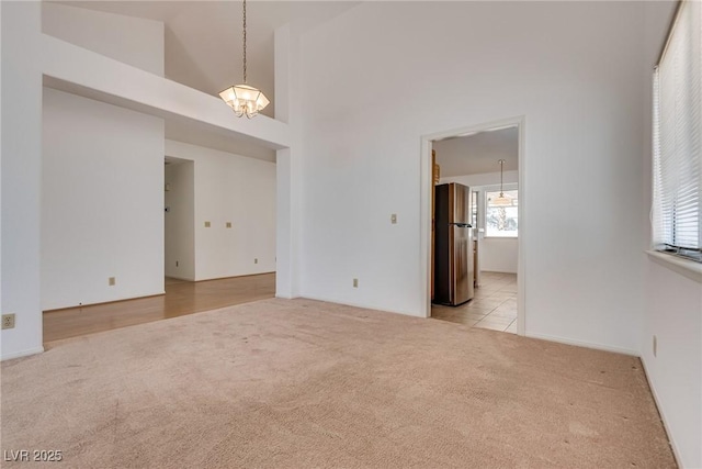 2904 Channel Bay Dr, Las Vegas, NV 89128 - empty room featuring light carpet and a chandelier