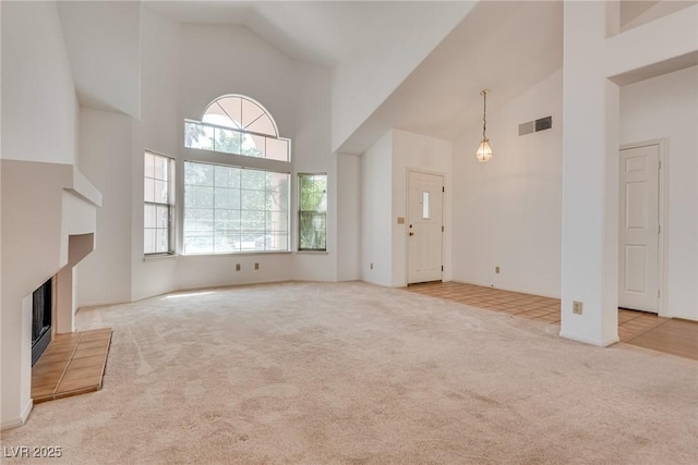 2904 Channel Bay Dr, Las Vegas, NV 89128 - unfurnished living room with high vaulted ceiling, carpet flooring, and a tile fireplace