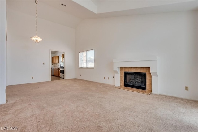 2904 Channel Bay Dr, Las Vegas, NV 89128 - unfurnished living room featuring carpet flooring, high vaulted ceiling, and a tiled fireplace