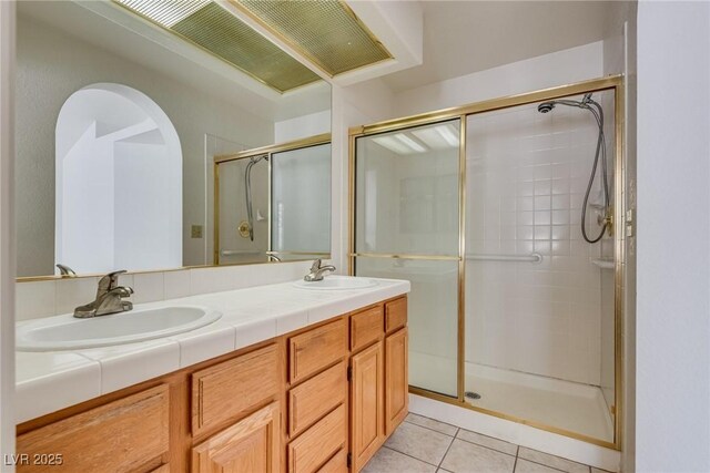 2904 Channel Bay Dr, Las Vegas, NV 89128 - full bathroom featuring tile patterned floors, a stall shower, and double vanity