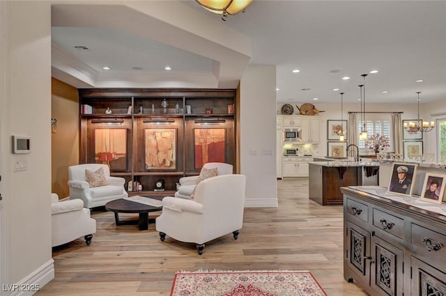 748 Puerto Real Ct, Las Vegas, NV 89138 - living area featuring light wood-type flooring, baseboards, recessed lighting, a tray ceiling, and a chandelier