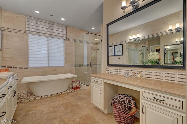 748 Puerto Real Ct, Las Vegas, NV 89138 - full bath with a stall shower, a freestanding tub, vanity, recessed lighting, and tile walls