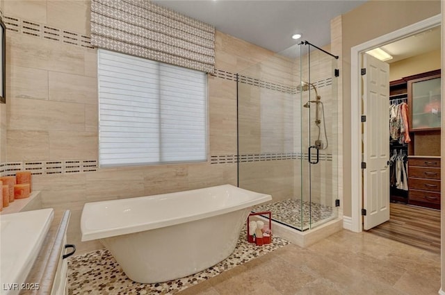 748 Puerto Real Ct, Las Vegas, NV 89138 - full bathroom with a shower stall, a soaking tub, a spacious closet, tile walls, and vanity